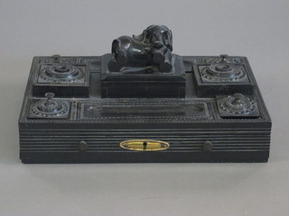 A carved ebony desk set decorated a seated elephant and with pen recess etc 12"