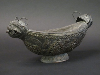 An Oriental pierced metal boat shaped vase raised on a spreading foot 16"
