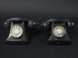 A pair of black Bakelite dial telephones, bases marked  N1025A1T