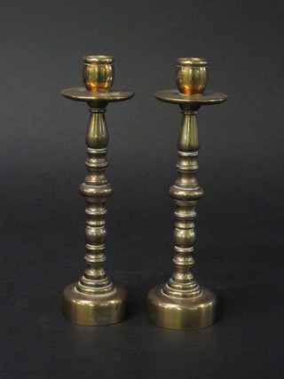 A pair of turned brass candlesticks 9"