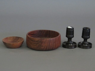 A pair of turned hardwood stub candlesticks 2" and 2 turned  wooden bowls 6" and 4"