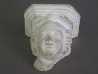 A plaster wall bracket in the form of a cherubs head 9"