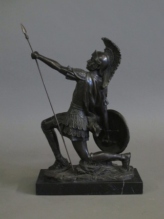 A bronze figure of a kneeling Greek warrior, raised on a  rectangular marble base 11"