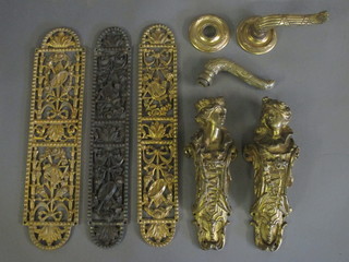 2 gilt ormolu mounts in the form of classical ladies, 3 pierced gilt metal door plates and a gilt metal door handle