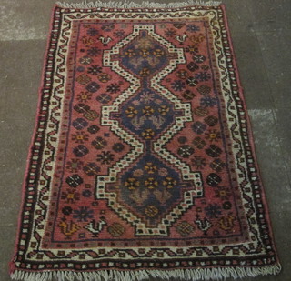 An Afghan rug with 3 octagons to the centre 57" x 37"