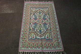 An Eastern wool work rug 60" x 34"