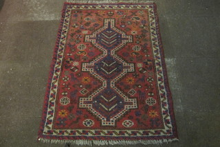 An Afghan rug with 3 octagons to the centre 56" x 38"