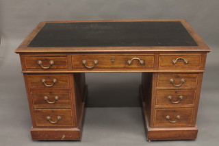An Edwardian inlaid mahogany kneehole writing desk with inset tooled writing surface, fitted 1 long and 8 short drawers 48"