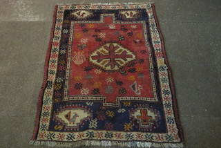 A red ground Afghan rug with central medallion 55" x 41 1/2"