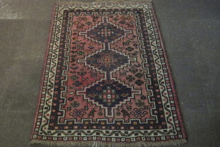 A red ground Afghan rug with 3 stylised octagons to the centre  58" x 42"