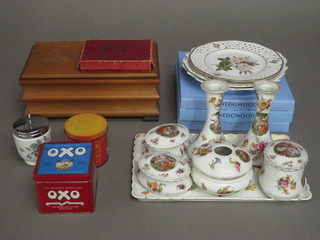 A 7 piece Edwardian pottery dressing table set comprising tray, pair of candlesticks, hair tidy and 3 jars and covers, 4 ribbon  ware plates, an egg coddler, 3 Wedgwood plates, a Pitt game, an  Oxo tin, a Spaghetti jigsaw puzzle and a wooden box containing  a collection of various tins