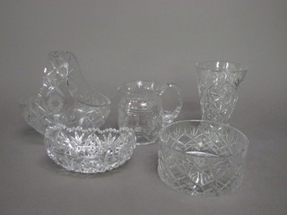 A cut glass basket 10", a circular bowl 7", a boat shaped cut  glass vase 8", a cut glass vase 9" and a cut glass jug