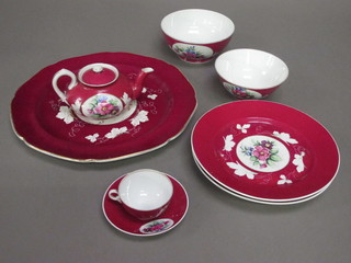 A 20 piece Imperial Russian Gardner porcelain tea service with  red ground and floral pattern comprising circular platter 13 1/2",  2 dishes 12", slop bowl 6 1/2", sugar bowl 6", teapot, 6 cups and  8 saucers together with 1 volume Marvin C Ross "Russian  Porcelain"