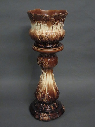 A brown glazed pottery jardiniere and stand, the base marked  Oxford