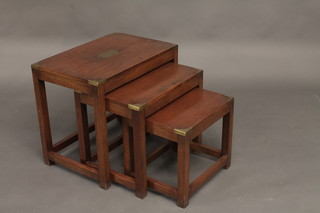 A nest of 3 rectangular mahogany military style interfitting coffee tables with brass corners 22"