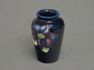 A Moorcroft blue glazed cylindrical vase decorated pansies, the base impressed Moorcroft 3 1/2"