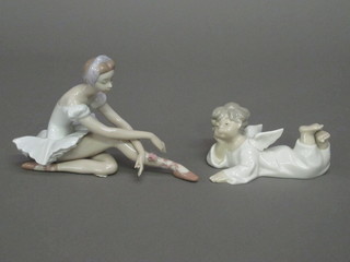 A Lladro figure of a reclining Angel 5", together with a figure of  a ballerina holding a rose, rose f, 7"