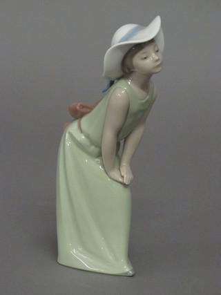 A Lladro figure of a girl in a green dress 9"