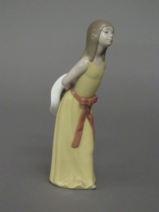 A Lladro figure of a girl in a brown dress 10"