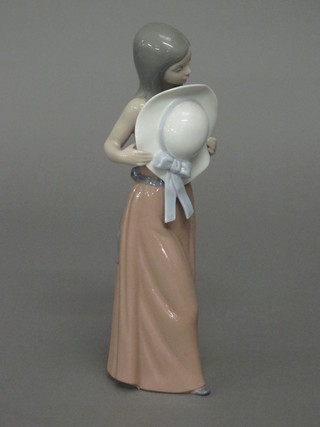 A Lladro figure of a girl in a pink dress 9"