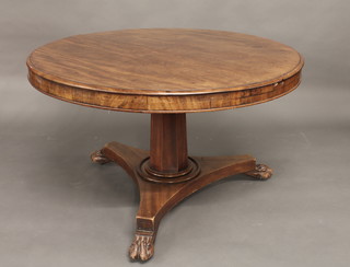 A William IV circular snap top mahogany breakfast table raised on turned chamfered column with triform base and paw feet 45"