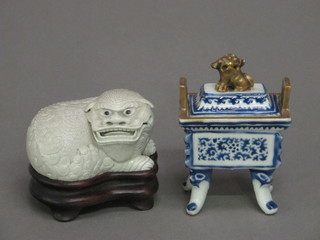 An Oriental white glazed porcelain figure of a Dog of Fo, the  base with seal mark 3", together with an Oriental blue and white  rectangular urn and cover 3"
