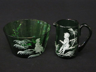 A Mary Gregory style green glass jug with enamelled decoration  of a seated child 3" and a matching bowl 5"
