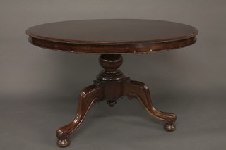 A circular Victorian mahogany snap top Loo table, raised on a pillar and tripod base 45"