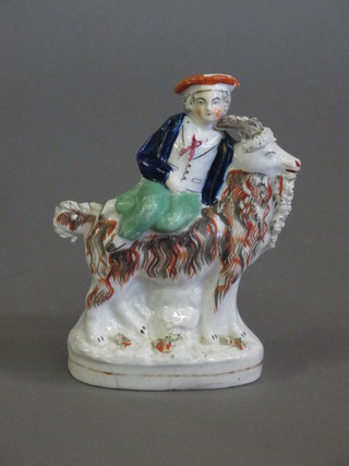 A 19th Century Staffordshire figure of a man seated on a goat 7"