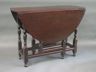 A 19th Century oak gateleg dining table raised on turned supports  41"