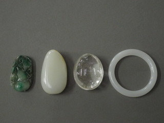A hardstone paperweight 3" and a rock crystal oval paperweight  2" and a white hardstone bangle
