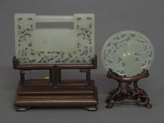 A rectangular carved and pierced green hardstone panel depicting  a figure 3" and a circular pierced hardstone panel depicting an  urn 2"  ILLUSTRATED