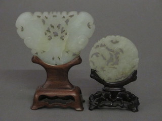 A carved and pierced Oriental green hardstone panel depicting a butterfly 3 1/2" and a circular panel depicting a figure 2"   ILLUSTRATED