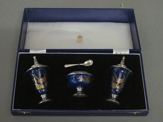 A porcelain and silver plated 3 piece condiment set with salt pot, mustard pot and table salt by Mappin & Webb, cased