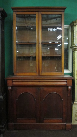 A 19th Century mahogany bookcase with moulded cornice the  interior fitted adjustable shelves 38", raised on an associated base  fitted a drawer above a double cupboard 47"
