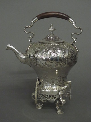 An embossed silver plated tea kettle and stand with spirit burner