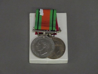 A pair of medals comprising Defence and War medal with cardboard box