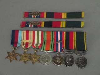 A group of 7 miniature medals comprising 1939-45 Star, African Star, Italy Star, Defence and War medal, George VI Territorial  Efficiency medal with HAC ribbon and a George VI Territorial  Efficiency medal with 2 HAC ribbon bars