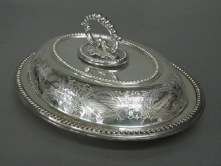 An oval engraved silver plated entree dish and cover