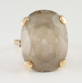 A lady's gold dress ring set a smoky quartz