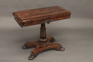 A William IV rosewood D shaped card table raised on a turned  and reeded column with triform base and paw feet 36"   ILLUSTRATED