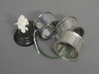 3 silver napkin rings, 1 other and a small ivory figure