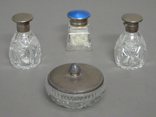 A square cut glass salt bottle with silver and blue enamelled lid, Birmingham 1928, a cut glass powder bowl and 2 matching scent  bottles with silver lids, 1 f, Birmingham 1937
