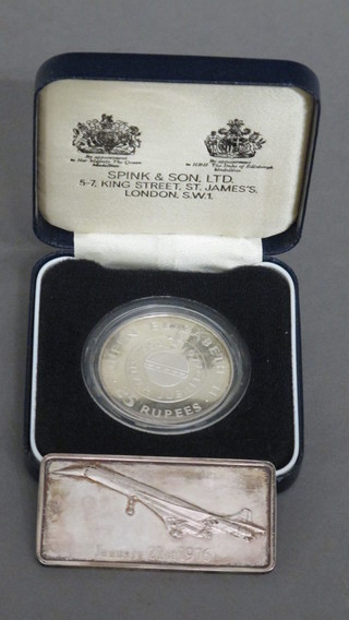 A silver ingot to commemorate Concorde and a silver proof coin  to commemorate the Queen's Silver Jubilee