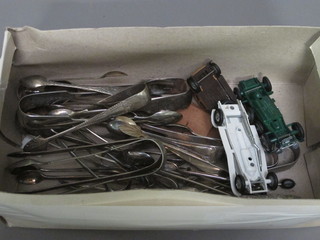 A collection of silver plated tongs and 2 model cars