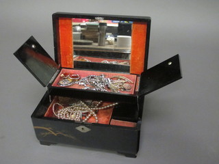 A lacquered jewellery box containing a collection of various costume jewellery