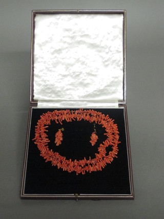 A suite of coral jewellery comprising pair of earrings and a necklace
