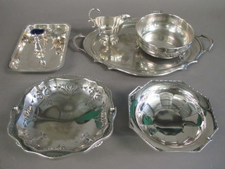 A silver plated sauce boat, 2 silver plated cake baskets with  swing handles, a 3 piece silver plated cruet set, a twin handled  dish with 3 feet, an entree dish lid and a twin handled silver  plated tea tray