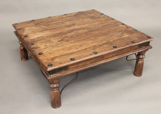 A square Eastern hardwood table with stud work decoration,  raised on turned supports 40"
