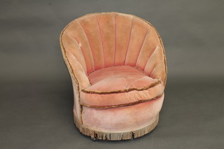 A 1930's mahogany framed armchair with scallop shaped back, upholstered in pink material